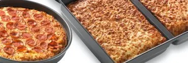 Custom pizza pans that Chicago Metallic manufactured for Little Caesars